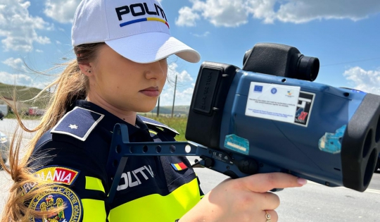 Romanian policewoman is measuring speed with a radar gun