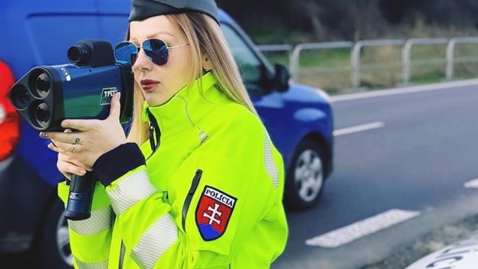 Slovak policewoman is measuring speed with a radar gun